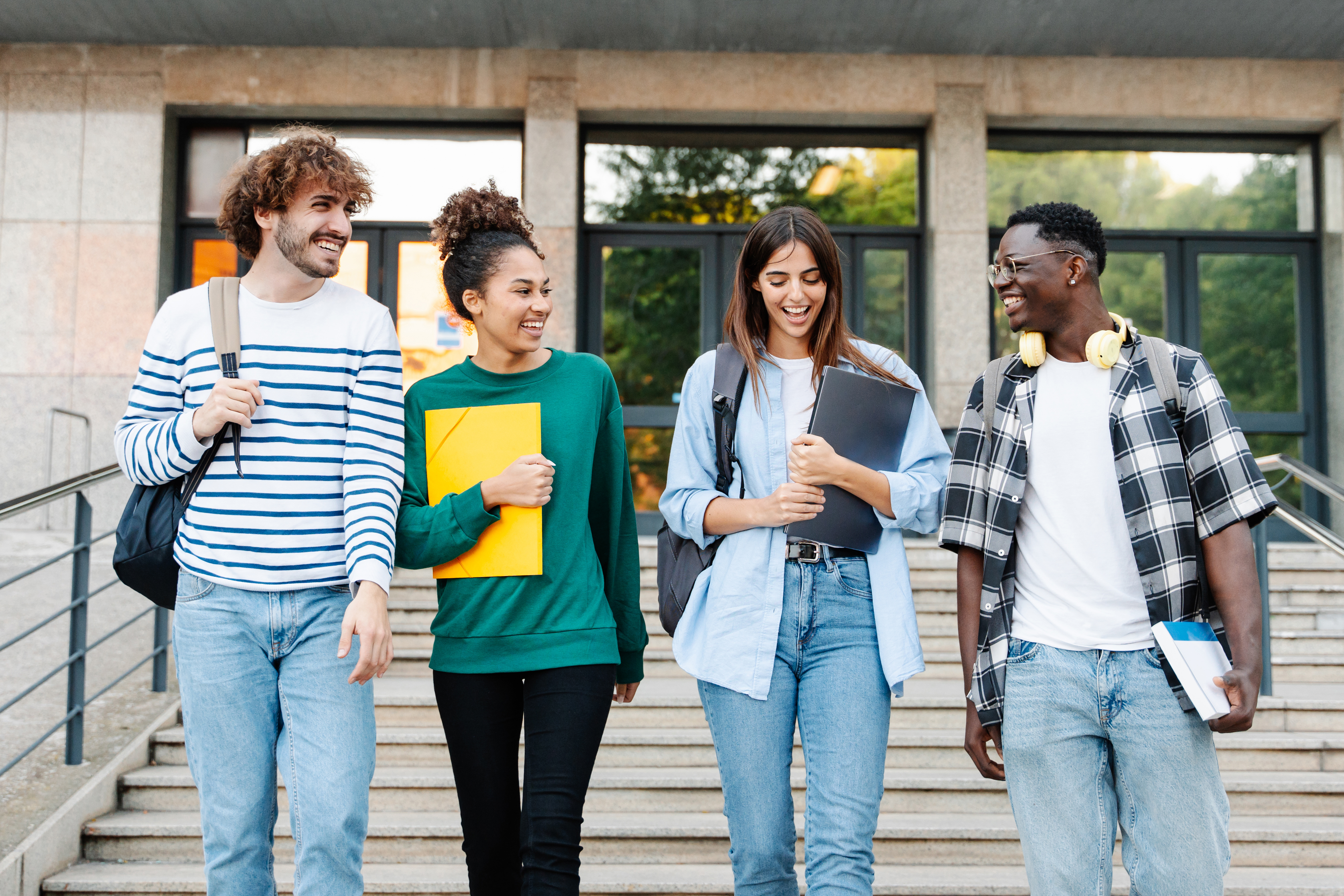 A group of college students walk outside of campus after class.